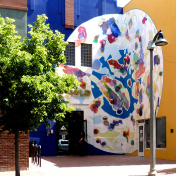 Photo of a round abstract mural that looks like a petri dish.