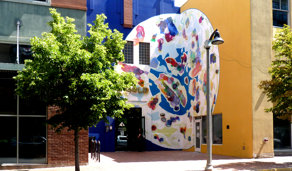 Photo of a round abstract mural that looks like a petri dish.