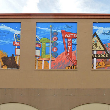 Photo of three murals side-by-side on a building wall of historical signs along Rt66 in Albuquerque.