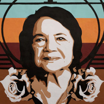 Mural of an older hispanic woman's portrait with roses.