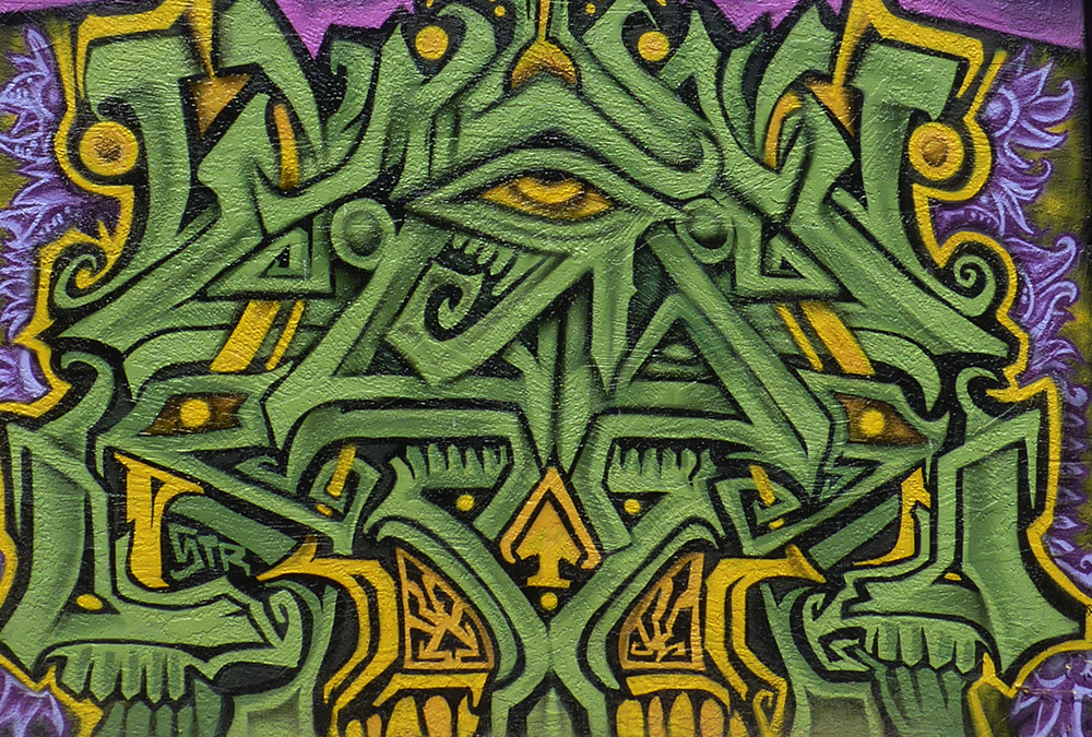 Mural that is green like grass or money that looks like a symbol of the illuninati's all seeing eye.