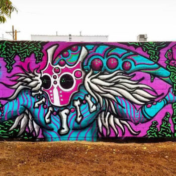 mural on a freestanding wall of a futuristic shaman creature. a little bit anime.