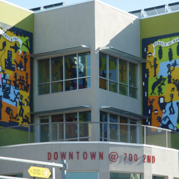 stick figure art murals on wall downtown