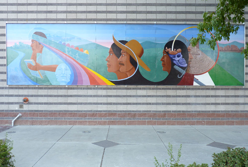 A dated mural of people in a field and a rainbow. made of ceramic tiles.