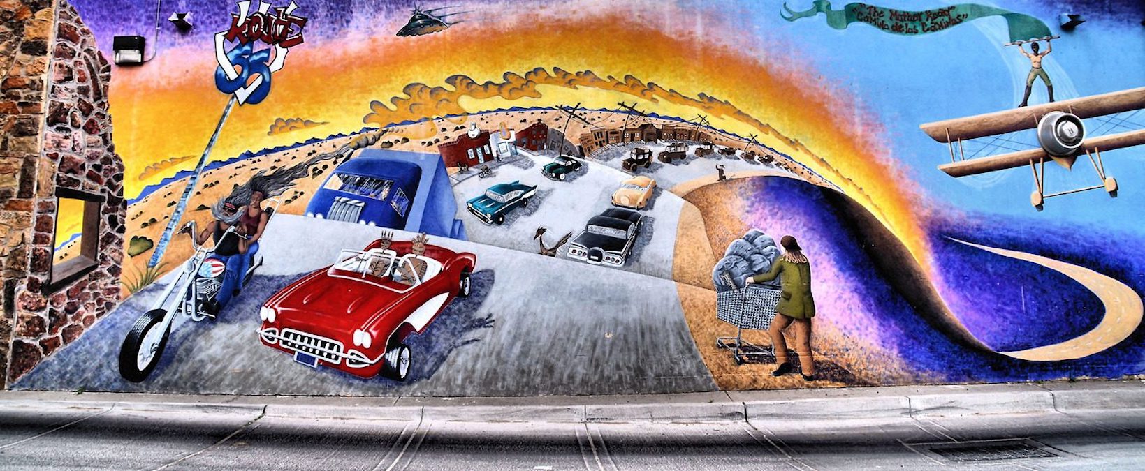 painting of cars on highway in desert