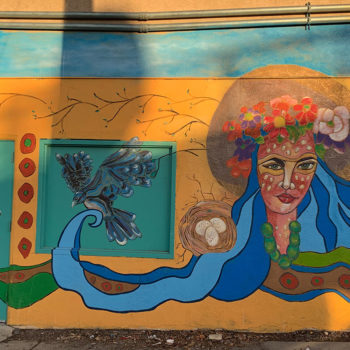 mural of woman with flowing hair and bird with nest