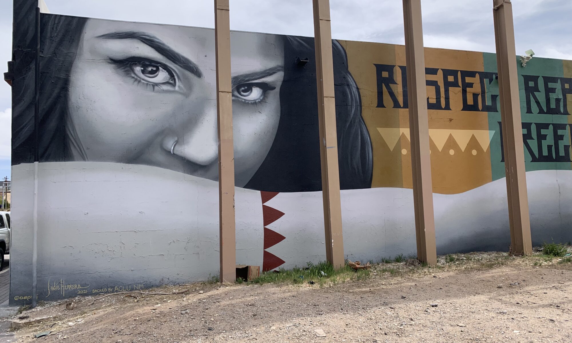 large face of woman with mural title