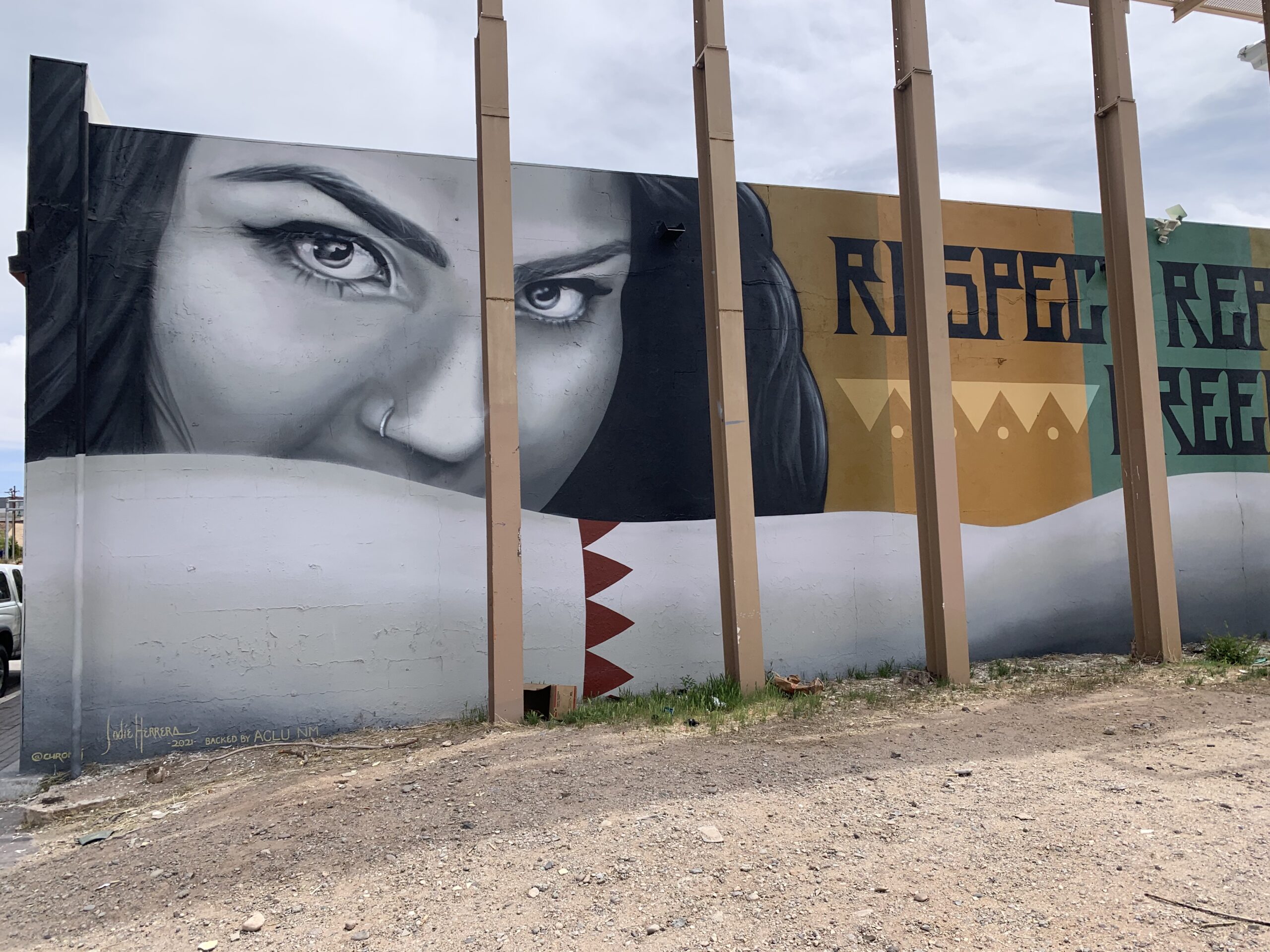 large face of woman with mural title