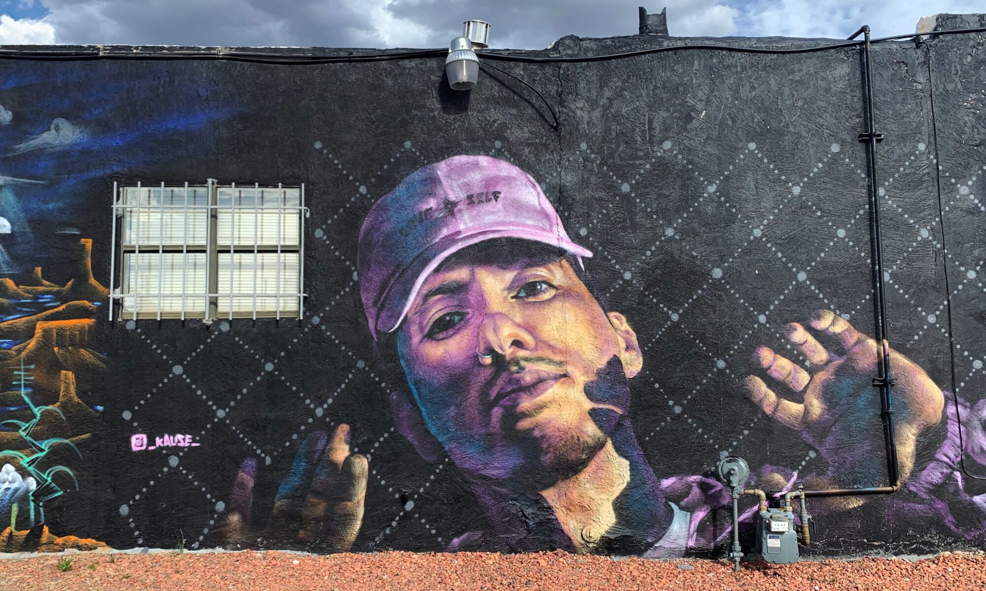 man wearing cap with mural title on it