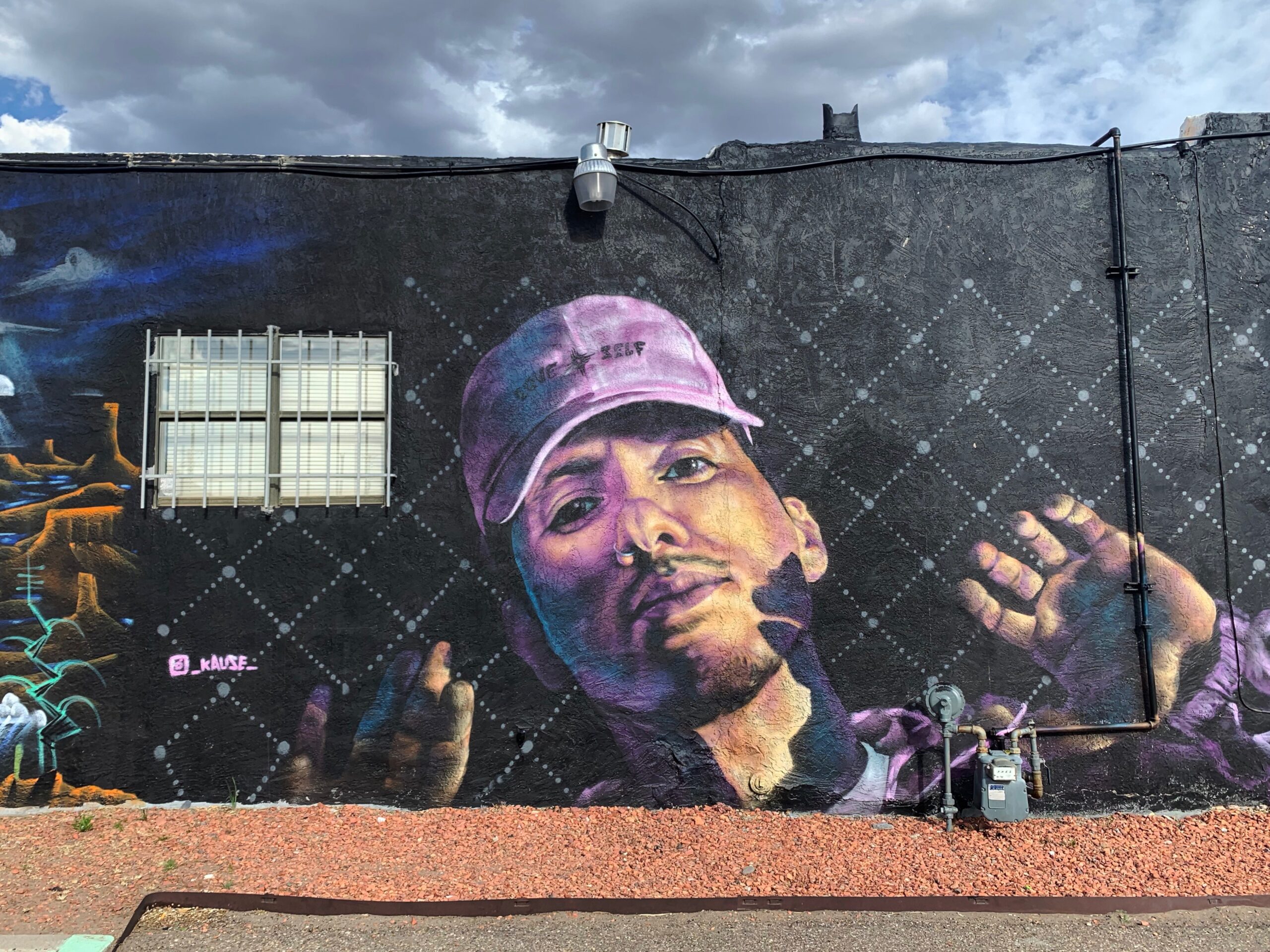 man wearing cap with mural title on it